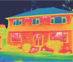 Thermal imagery showing heat loss from first floor double glazing is far less than that of the single glazing on the ground floor.